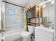Bathroom featuring a tub, updated fixtures, and wooden cabinet at 440 42Nd N St, St Petersburg, FL 33713