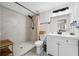 Updated bathroom with stylish tile floors, modern vanity, and walk-in shower with black hardware at 440 42Nd N St, St Petersburg, FL 33713
