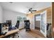 Bedroom featuring hardwood flooring, a ceiling fan, and accent wall at 440 42Nd N St, St Petersburg, FL 33713