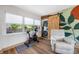 Versatile bonus room with wooden floors, accent wall, exercise bike, and multiple windows at 440 42Nd N St, St Petersburg, FL 33713