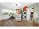 Bonus room with wooden floors, accent wall, barn door, exercise bike and multiple windows at 440 42Nd N St, St Petersburg, FL 33713