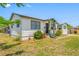 A charming single-story home features a well-manicured lawn and beautifully landscaped flower beds at 440 42Nd N St, St Petersburg, FL 33713