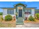 Inviting front porch with a well-manicured lawn and colorful landscaping, adding charm and curb appeal at 440 42Nd N St, St Petersburg, FL 33713