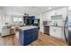 Open concept kitchen with island, stainless appliances, and bar seating area at 440 42Nd N St, St Petersburg, FL 33713
