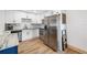 Updated kitchen with stainless steel appliances, granite counters, white cabinets, and wood-look floors at 440 42Nd N St, St Petersburg, FL 33713