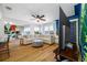 Bright living room boasts hardwood floors, fan, large sectional, and stylish accent wall detail at 440 42Nd N St, St Petersburg, FL 33713