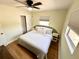 Comfortable main bedroom with wood flooring, ceiling fan, and closet at 440 42Nd N St, St Petersburg, FL 33713