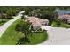 Aerial view of the property showcasing the expansive lawn, mature trees, and cul-de-sac location at 4696 Del Sol Blvd, Sarasota, FL 34243