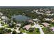 Stunning aerial view of the community with mature trees and a large pond nearby luxury homes at 4696 Del Sol Blvd, Sarasota, FL 34243