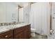 Bathroom features a dark wood vanity with neutral countertop and tile shower at 4696 Del Sol Blvd, Sarasota, FL 34243