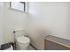 Small half-bathroom features a standard toilet and basic fixtures in a tight space at 4696 Del Sol Blvd, Sarasota, FL 34243