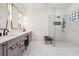 Modern bathroom featuring a glass shower, dual sinks and sleek, gray cabinets at 4696 Del Sol Blvd, Sarasota, FL 34243