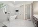 This stunning bathroom includes a soaking tub and a glass block window feature at 4696 Del Sol Blvd, Sarasota, FL 34243
