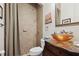Bathroom with a vessel sink on a marble vanity and tiled shower at 4696 Del Sol Blvd, Sarasota, FL 34243