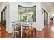 Cozy breakfast nook with hardwood floors, a table, chairs, and natural light at 4696 Del Sol Blvd, Sarasota, FL 34243