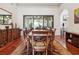Spacious dining room featuring hardwood floors, large table, and patio access at 4696 Del Sol Blvd, Sarasota, FL 34243