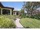 Landscaped walkway leads to the home, showcasing its curb appeal and inviting entrance at 4696 Del Sol Blvd, Sarasota, FL 34243
