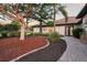 Exterior view of a home featuring lush landscaping, a paver walkway, and a barrel tile roof at 4696 Del Sol Blvd, Sarasota, FL 34243