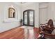 Home foyer features ornate double doors, hardwood floors, and elegant mirror at 4696 Del Sol Blvd, Sarasota, FL 34243