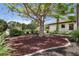 The front yard features a large tree and decorative rock cover, with landscaping at 4696 Del Sol Blvd, Sarasota, FL 34243