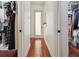 Bright hallway with hardwood floors, connecting the dressing room and closet at 4696 Del Sol Blvd, Sarasota, FL 34243