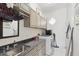 Bright laundry room featuring front load machines, granite counters and cabinets at 4696 Del Sol Blvd, Sarasota, FL 34243
