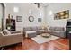 Bright living room features a gray sectional sofa, wood floors, and recessed lighting at 4696 Del Sol Blvd, Sarasota, FL 34243