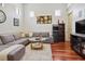 Cozy living room featuring hardwood floors, a comfortable sectional, and stylish decor at 4696 Del Sol Blvd, Sarasota, FL 34243
