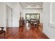 Elegant dining room with hardwood floors, tray ceiling, and sliding glass doors to outdoor living space at 4696 Del Sol Blvd, Sarasota, FL 34243