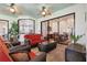Covered patio with outdoor seating and a view of the dining room through sliding glass doors at 4696 Del Sol Blvd, Sarasota, FL 34243