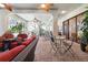 Spacious covered patio area featuring outdoor seating, ceiling fans, and brick floors at 4696 Del Sol Blvd, Sarasota, FL 34243