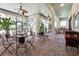 Spacious covered patio features brick flooring, ceiling fans, an outdoor kitchen, and plenty of seating at 4696 Del Sol Blvd, Sarasota, FL 34243