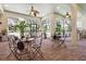 Covered patio showcasing outdoor seating arrangements, ceiling fans, and brick floors at 4696 Del Sol Blvd, Sarasota, FL 34243