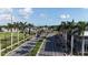 A beautifully landscaped street with palm trees and well maintained greenery leading to the shopping center at 4696 Del Sol Blvd, Sarasota, FL 34243