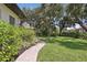 Lush green lawn and mature landscaping create a serene and inviting outdoor space at 4696 Del Sol Blvd, Sarasota, FL 34243
