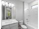 Modern bathroom with white subway tile, quartz countertop vanity, and shower-tub combo for a clean, spa-like feel at 4988 Fairhope Cir, Lakewood Ranch, FL 34211