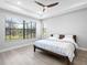 Bright bedroom with large windows and a tray ceiling at 4988 Fairhope Cir, Lakewood Ranch, FL 34211