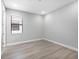 Empty bedroom with a large window and hardwood floors at 4988 Fairhope Cir, Lakewood Ranch, FL 34211