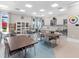 Spacious craft room with tables, chairs, cabinets, and bright lighting at 4988 Fairhope Cir, Lakewood Ranch, FL 34211