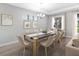Bright dining room featuring modern decor, elegant lighting, and a view of the pool at 4988 Fairhope Cir, Lakewood Ranch, FL 34211