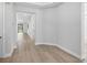 Hallway with wood-look flooring leading to a bathroom and a view of the outdoor pool at 4988 Fairhope Cir, Lakewood Ranch, FL 34211