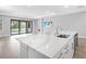 Kitchen island with quartz countertop and stainless sink overlooks living area and pool views at 4988 Fairhope Cir, Lakewood Ranch, FL 34211