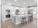 Modern kitchen featuring stainless appliances, white cabinets, and a large island with room for seating at 4988 Fairhope Cir, Lakewood Ranch, FL 34211