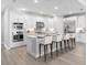 Modern kitchen with white cabinets, stainless steel appliances, and a large center island with seating at 4988 Fairhope Cir, Lakewood Ranch, FL 34211