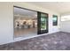 Patio view of a modern kitchen featuring a center island with white cabinets and stainless appliances at 4988 Fairhope Cir, Lakewood Ranch, FL 34211