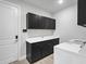 Functional laundry room with ample cabinet space and modern appliances at 4988 Fairhope Cir, Lakewood Ranch, FL 34211