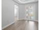 Bright living room featuring wood-look flooring and French doors that let in natural light at 4988 Fairhope Cir, Lakewood Ranch, FL 34211