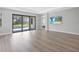 Spacious living room with hardwood floors and sliding glass doors to the pool area at 4988 Fairhope Cir, Lakewood Ranch, FL 34211