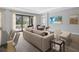 Comfortable living room with a neutral color scheme, hardwood floors, and a view to the patio at 4988 Fairhope Cir, Lakewood Ranch, FL 34211