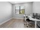 Bright office space with a large window, light wood floors, and modern desk setup for a productive work environment at 4988 Fairhope Cir, Lakewood Ranch, FL 34211